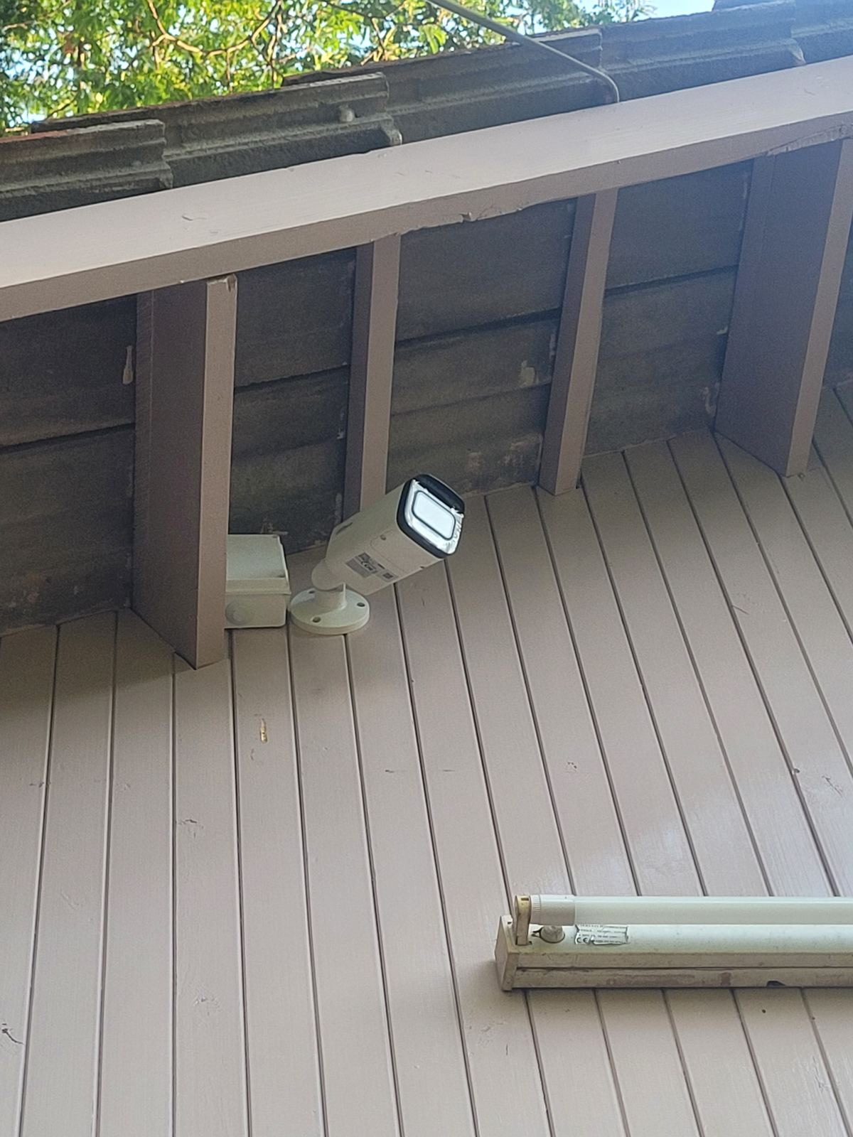 CCTV bullet camera installed under a deck roof