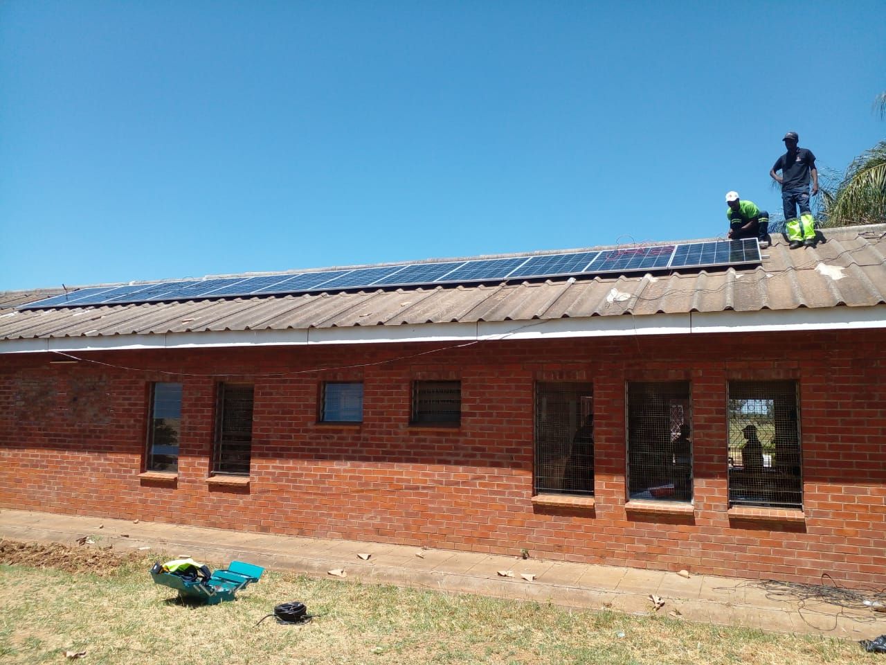 DeBle Solutions technicians installing solar panels on a rooftop
